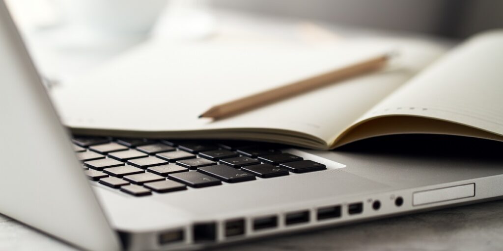 Closeup of Workspace with Modern Creative Laptop, Cup of Coffee Nieuws van verzekerjouw taxi.nl